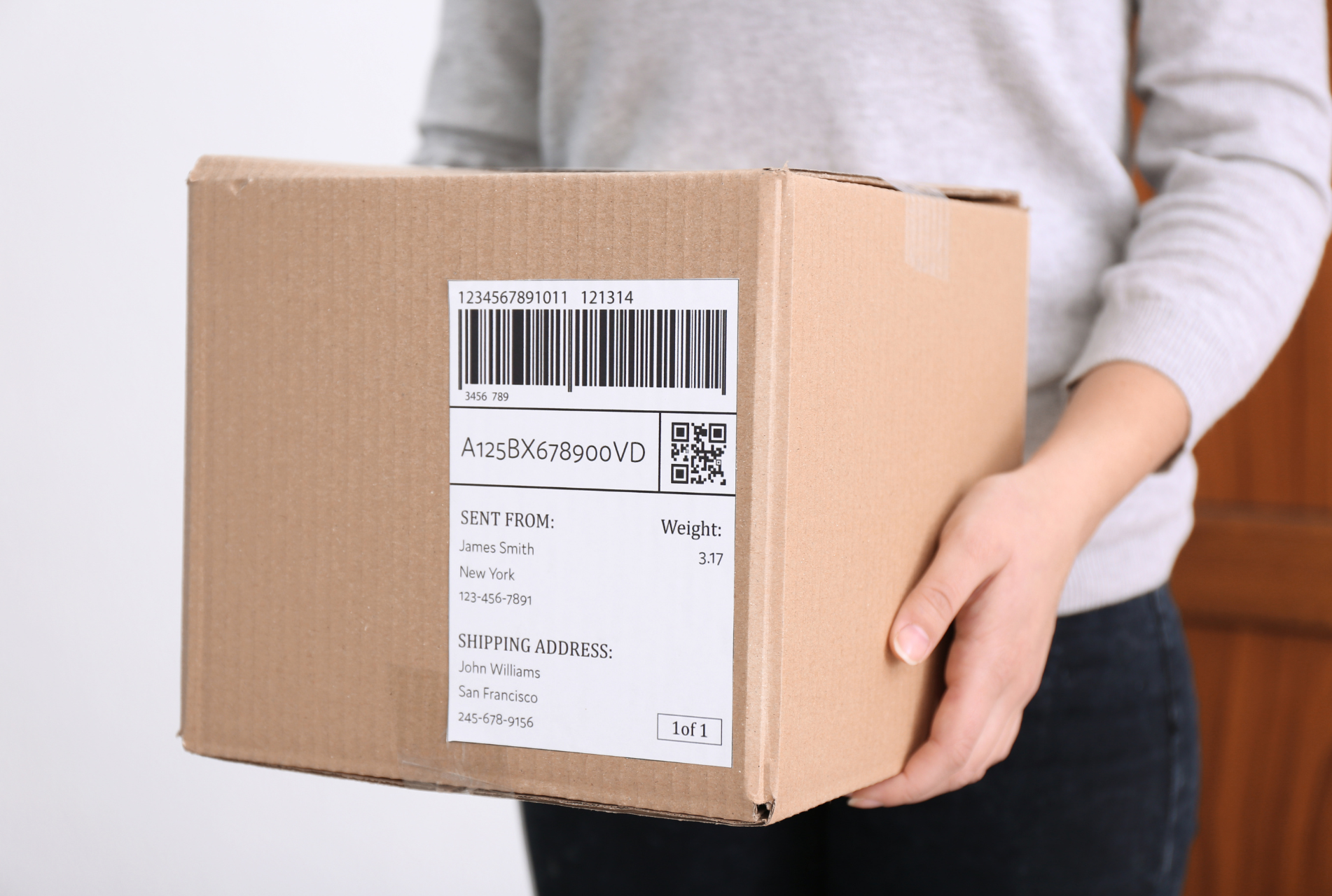 Box with barcode label being carried